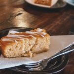 Small, rectangular gluten free pastry on a plate with a napkin